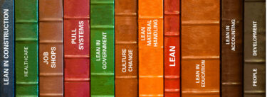 row of books on a shelf with spines showing