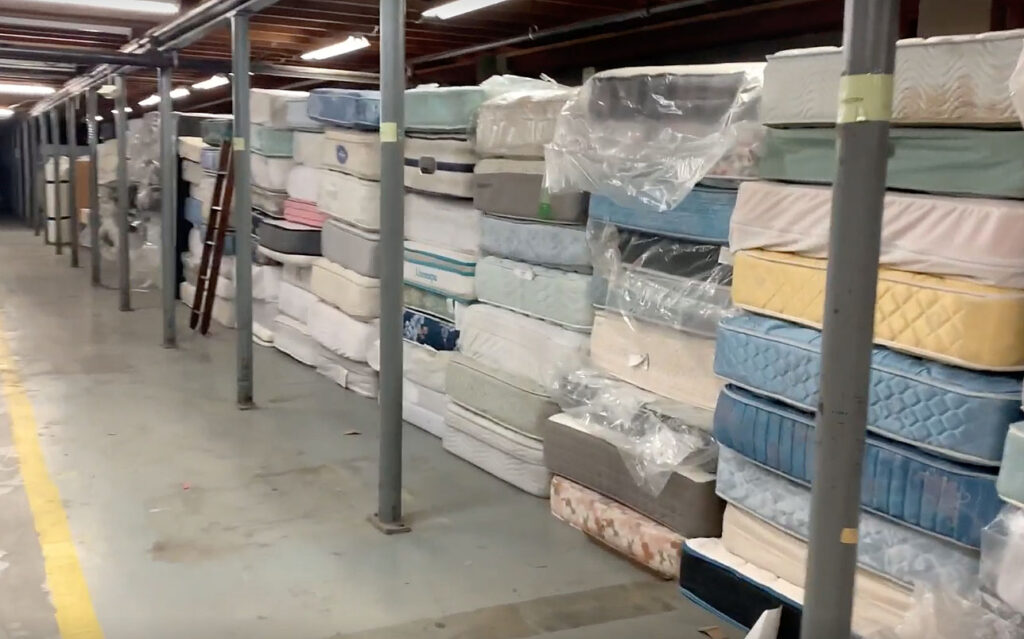 warehouse after, mattresses stacked. Items organized.