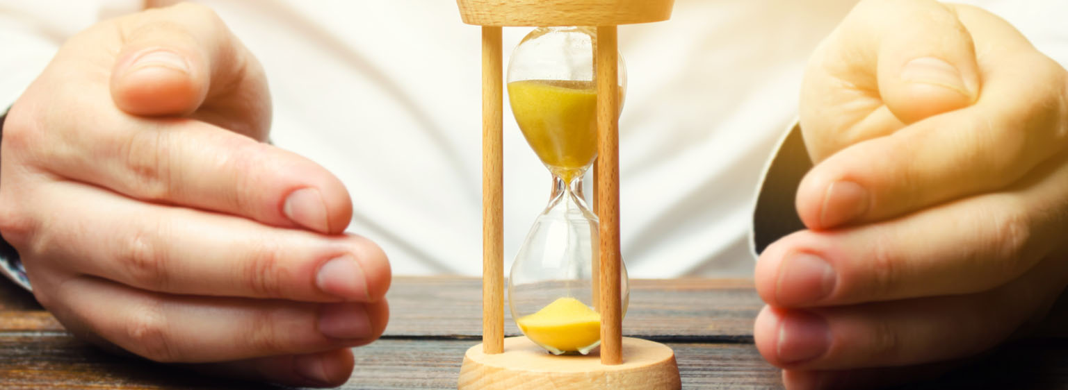 an hour glass surrounded by hands