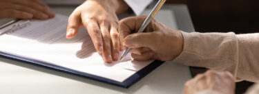 person signing a contract